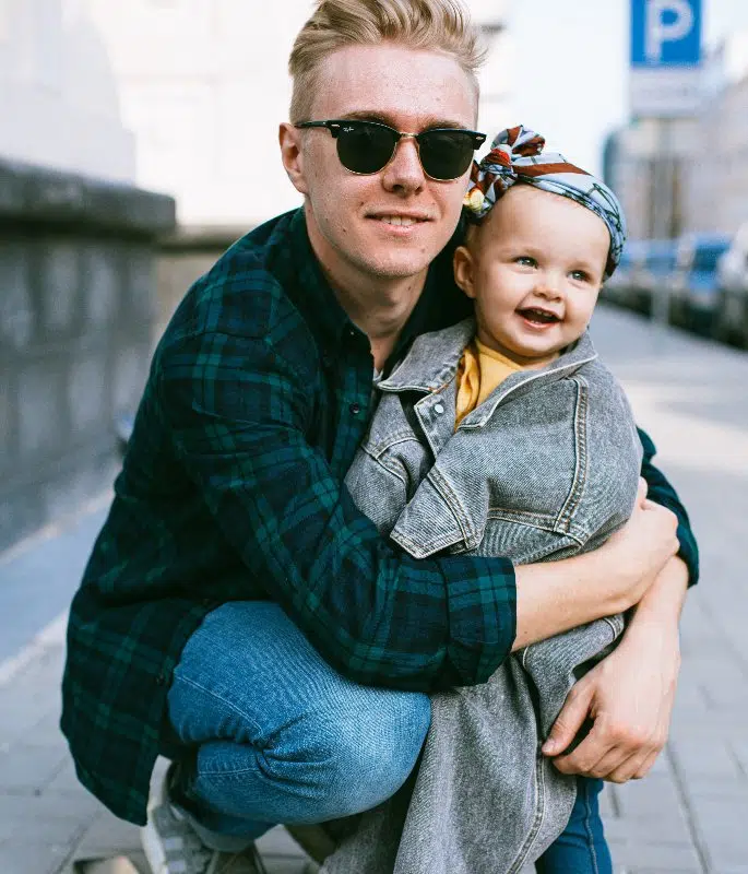 Man With Sunglasses Embracing His Son Baby